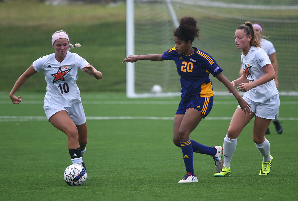 Devin Dowell, Sellena Dixon and Morgan Lange race to the ball